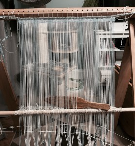 This photo shows the warp-weighted loom set up and a couple of centimetres have have woven.